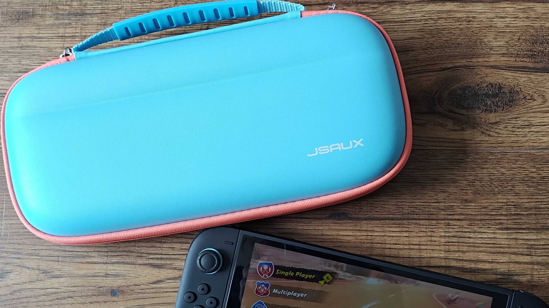 Jsaux Switch 2 carry case on woodgrain surface with Switch 2 underneath.