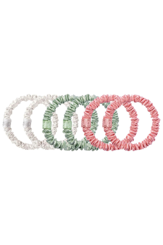 set of white, green, and pink silk hair ties on a white background