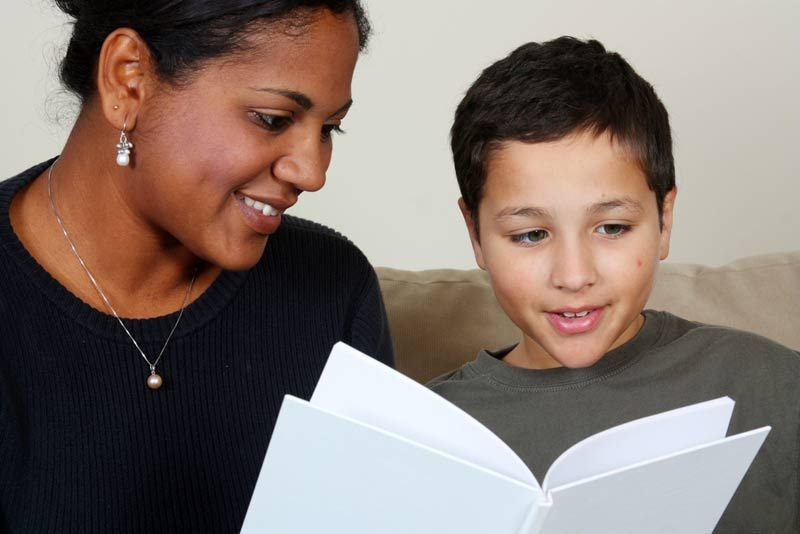 a mother helping her son with homework