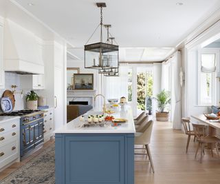 kitchen with blue island white countertops range cooker and vintage rug