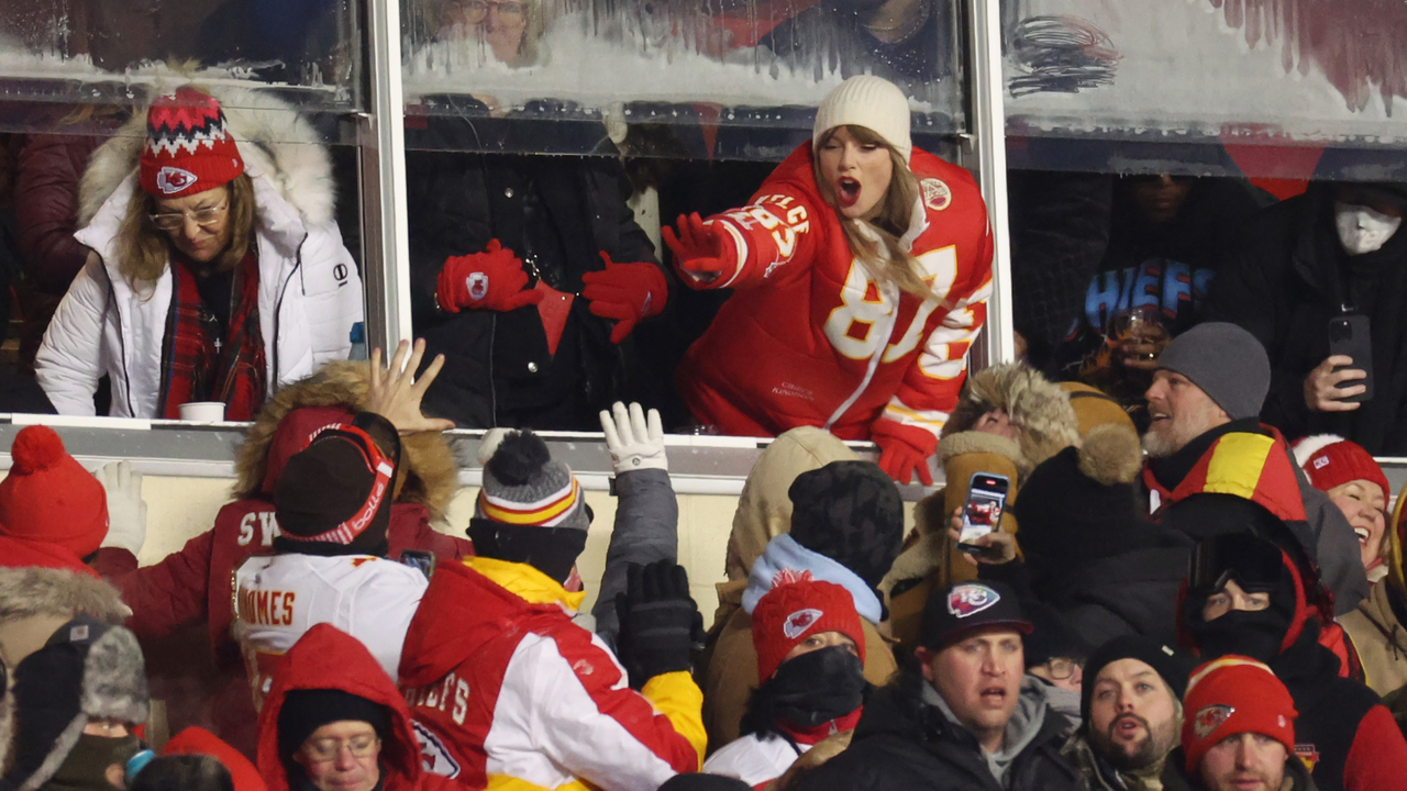 Taylor Swift celebrates with fans during the AFC Wild Card Playoffs between the Miami Dolphins and the Kansas City Chiefs at GEHA Field at Arrowhead Stadium on January 13, 2024 in Kansas City, Missouri. 