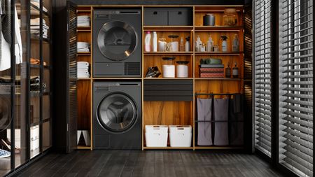 Luxurious laundry room interior with washing machine, dryer, laundry basket and folded towels In The Cabinet