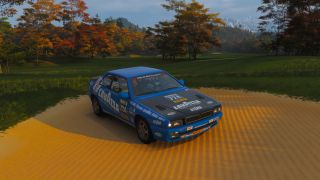 Forza Horizon 6 Naruo Golf Course: A 1997 Maserati Ghibli Cup with a blue livery parked in the sand at the golf course.