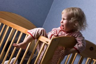 a toddler girl crying and throwing a temper tantrum,