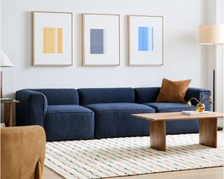 Living room with white rug and blue sofa