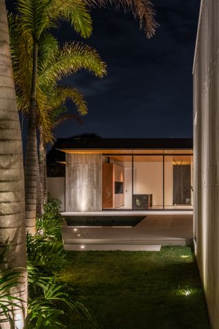 AG House by camila porto, a low brazilian house made of wood and exposed concrete