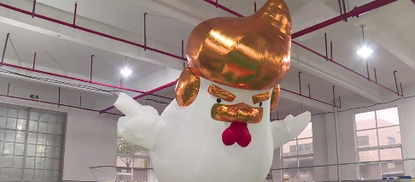 A giant Trump rooster being made in a Chinese factory. 
