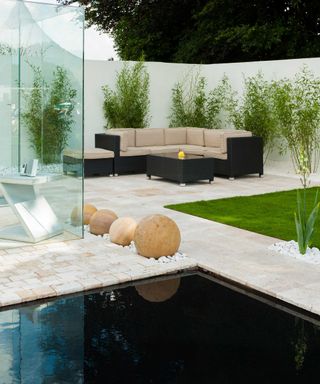 modern patio with pond and seating area