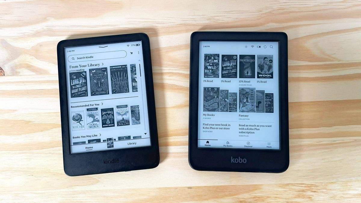 An Amazon Kindle and Kobo Clara BW side by side on a wood table showing each one's home screen