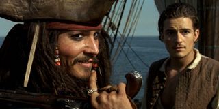 Pirates of the Caribbean: Curse of the Black Pearl Johnny Depp Orlando Bloom surveying the competiti