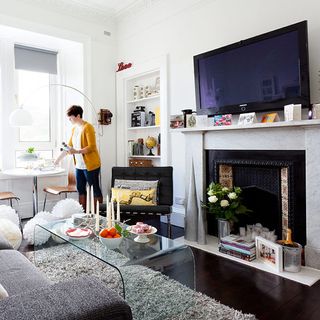 living area with white wall and fire place