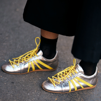 woman wearing silver sneakers 