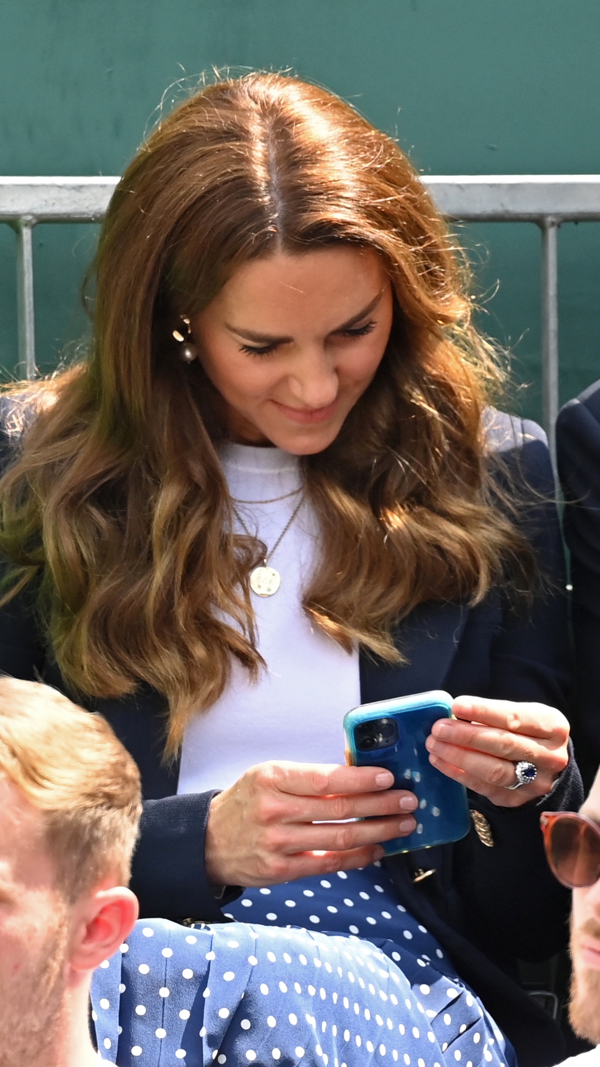 Catherine, Princess of Wales checks her phone while attending Wimbledon Championships Tennis Tournament 2021