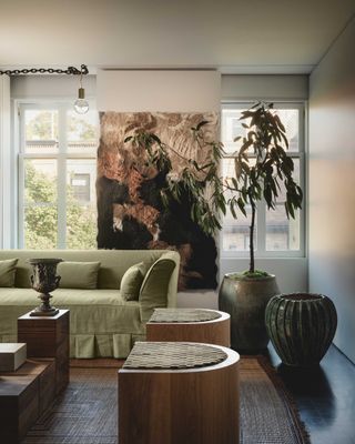 showroom with tree and green olive sofa