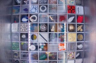 NanoRacks' Nanolab camera view of the 64 works of art comprising the Moon Gallery test payload now onboard the International Space Station for the next 10 months.