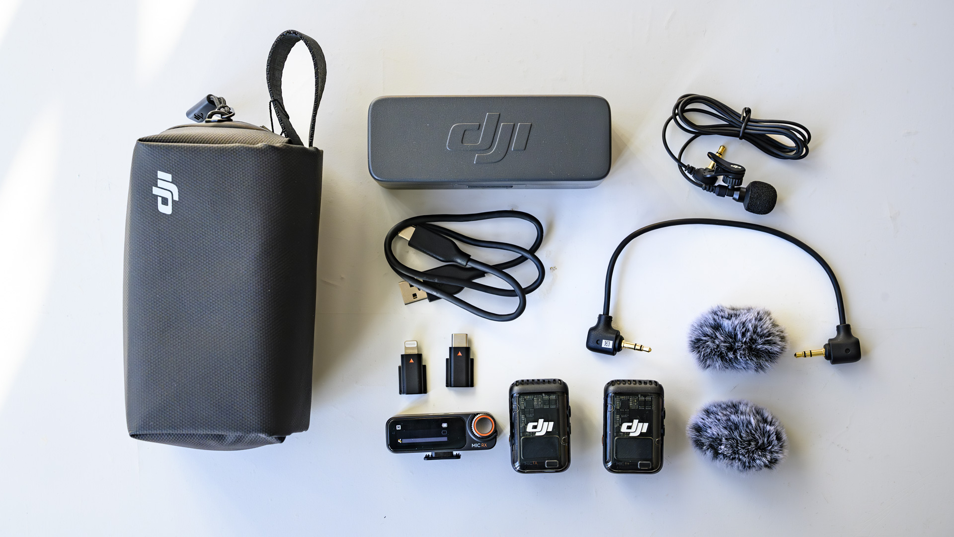 Flat lay of the complete DJI Mic 2 kit on white table