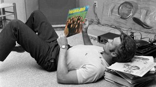 Clint Eastwood lying down on his back holding a copy of the Island Records sampler You Can All Join In (photoshopped image)