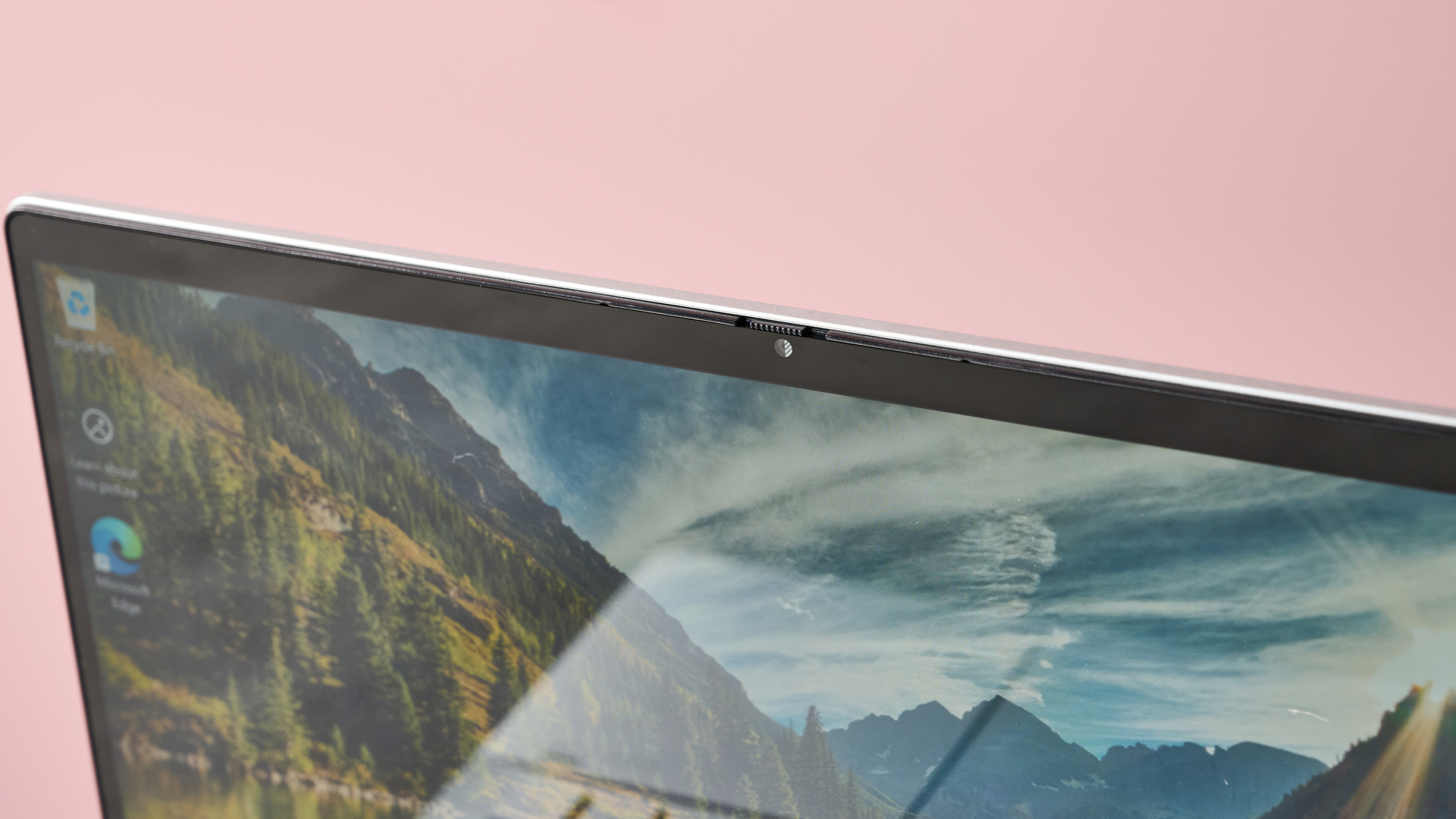 Close-up of webcam on HP Pavilion x360 14, with pink wall in background