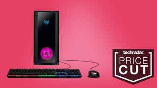 a large black PC, keyboard, and mouse against a pink background