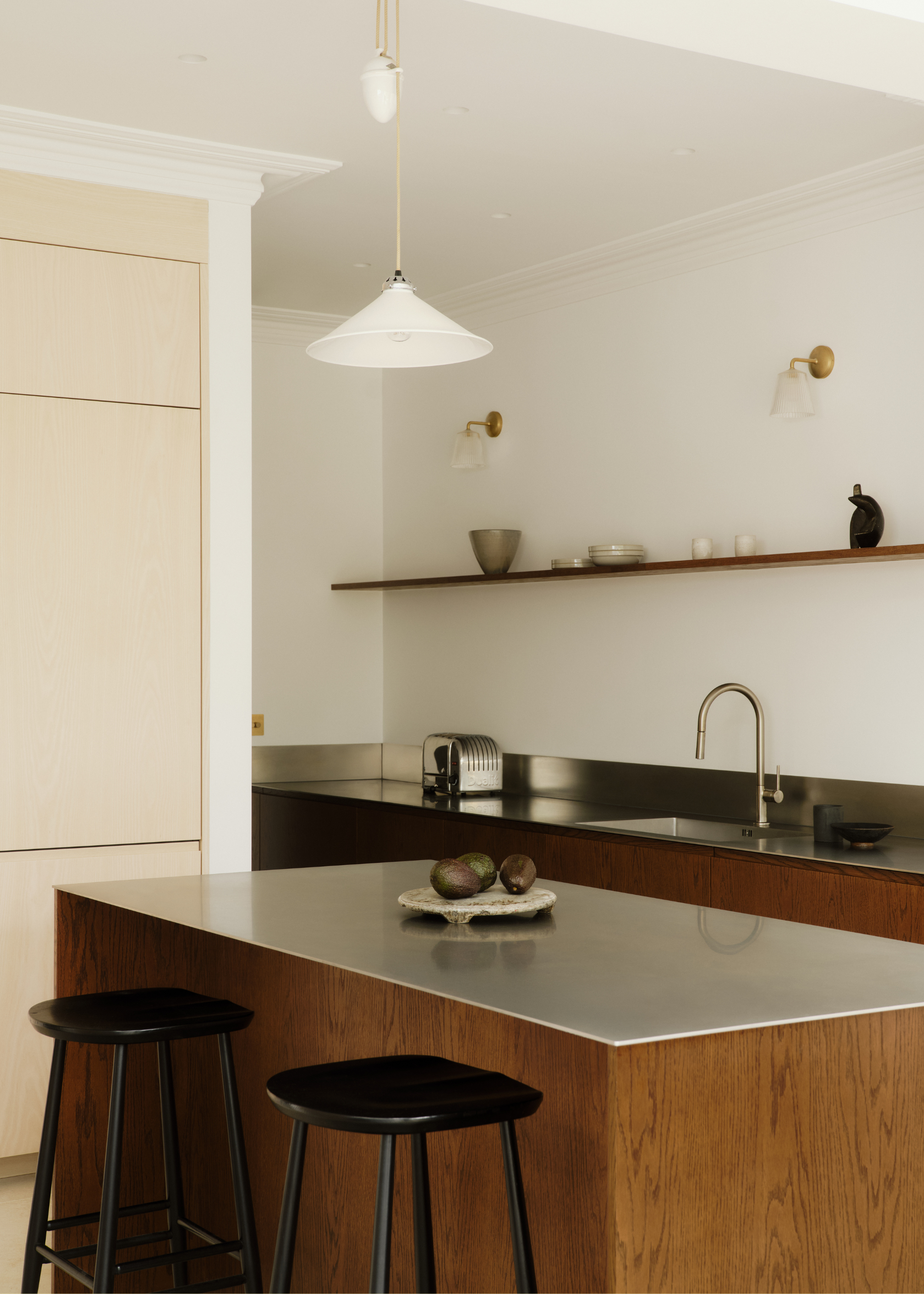 modern kitchen with stainless steel counters and wooden cabinetry