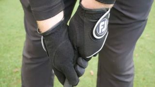 golfer wearing two FootJoy RainGrip Gloves