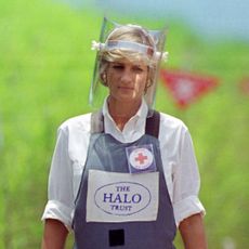 Princess Diana wears body armour and a face visor while walking across a landmine minefield being cleared by the charity Halo in Huambo, Angola