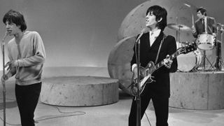Mick Jagger, left, Keith Richards, center, and Charlie Watts perform on 'The Ed Sullivan Show', October 25, 1964