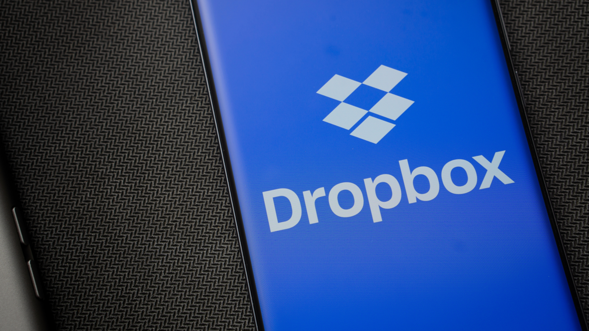 Dropbox logo is seen on a smartphone.