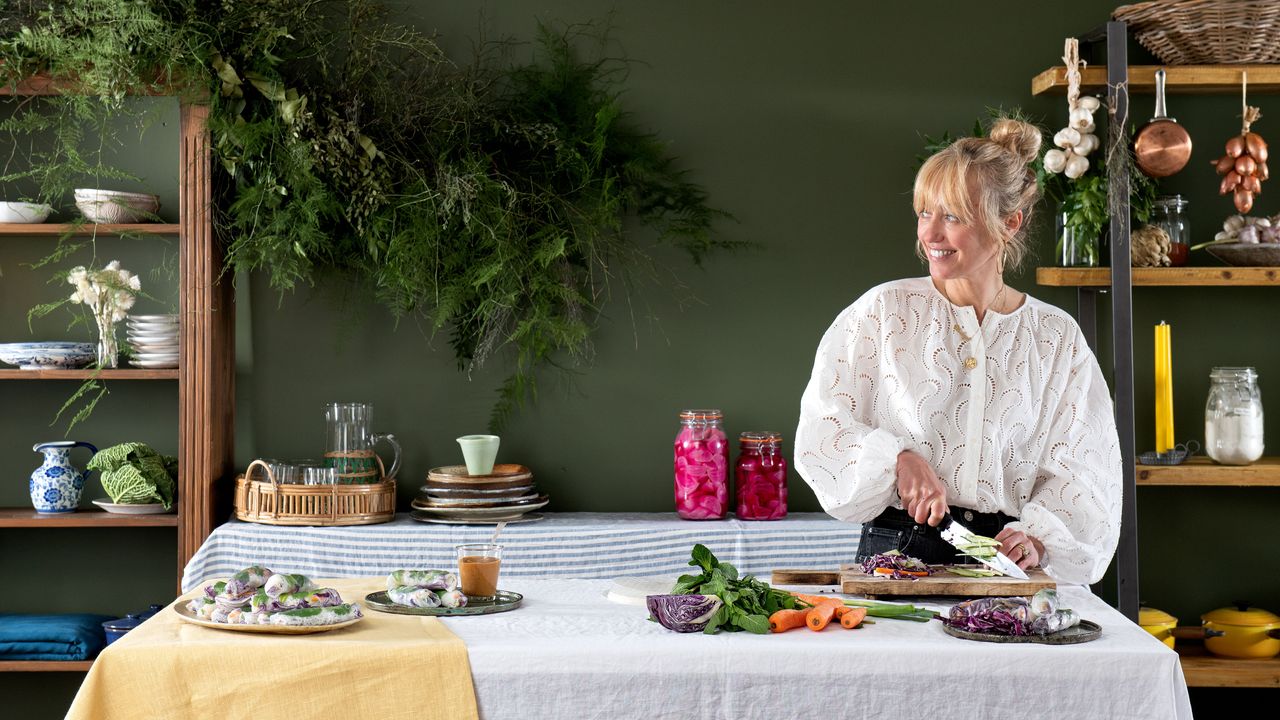 clodagh mckenna at a table chopping vegetables