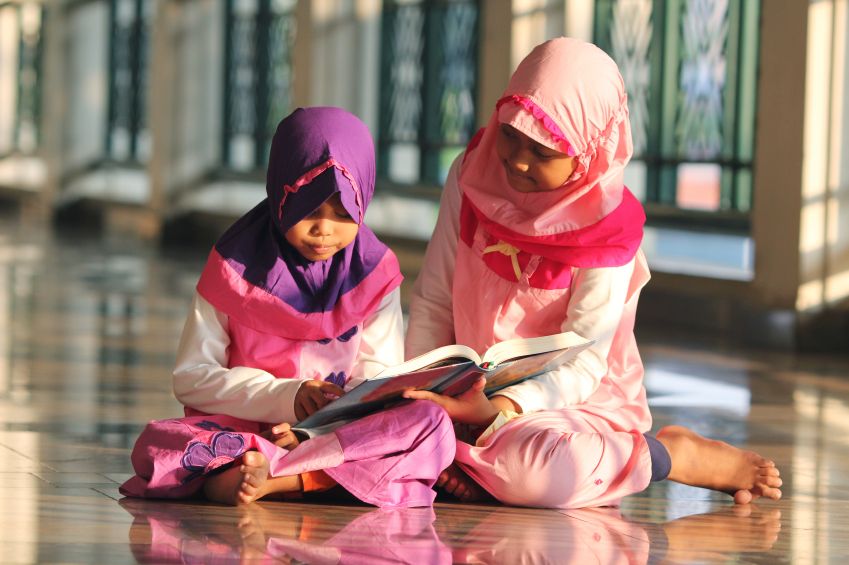 Children reading a book.