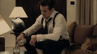 John Sugar (Colin Farell), wearing shirt, braces and tie, pours himself a drink in "Sugar"