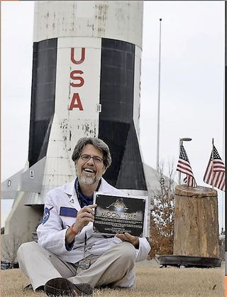 Scott Phillips with the remains of the Apollo 14 moon tree that stood at the Kennedy Space Center from 1976 to 2017.