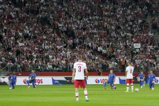 England players take the knee before the World Cup qualifier Poland.
