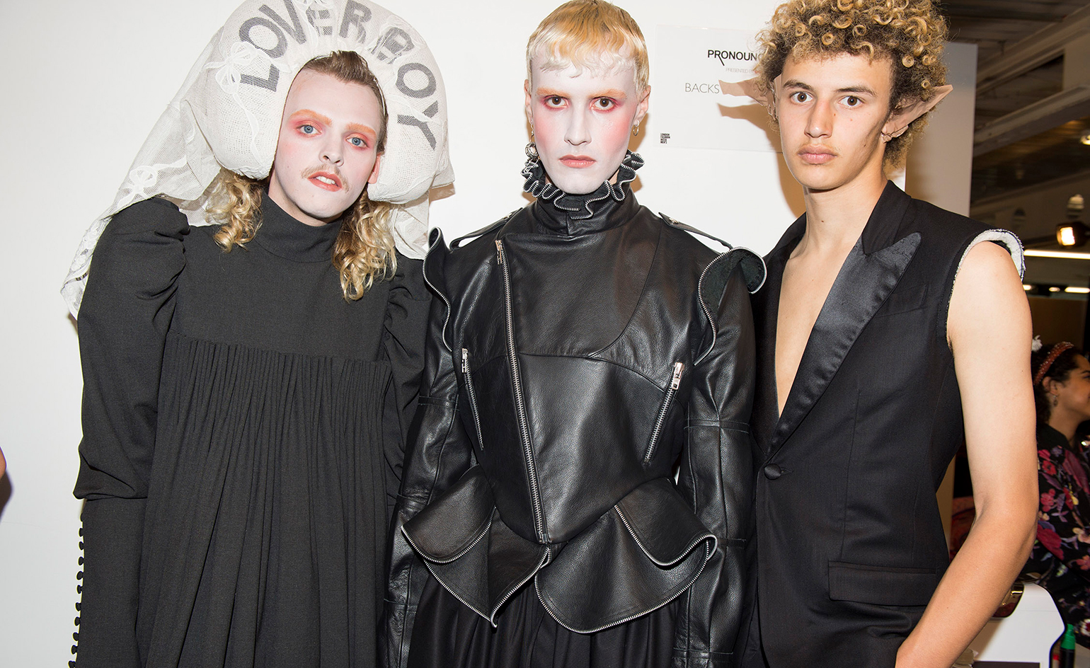 Models backstage wearing black leather, black dresses,blouses