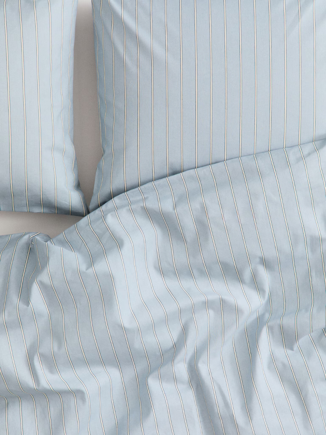 A pale blue sheet with beige stripes from H&amp;amp;M