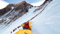 A queue of climbers waiting to reach the summit of Mount Everest