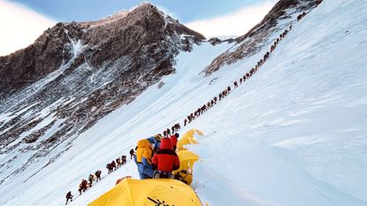 A queue of climbers waiting to reach the summit of Mount Everest