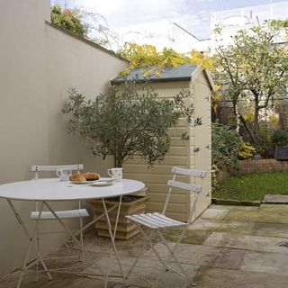 garden area with shack and table with chairs