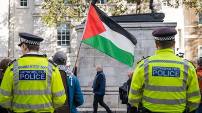 Police look on as pro-Palestinian protesters gather outside Downing Street, 14 October 2023