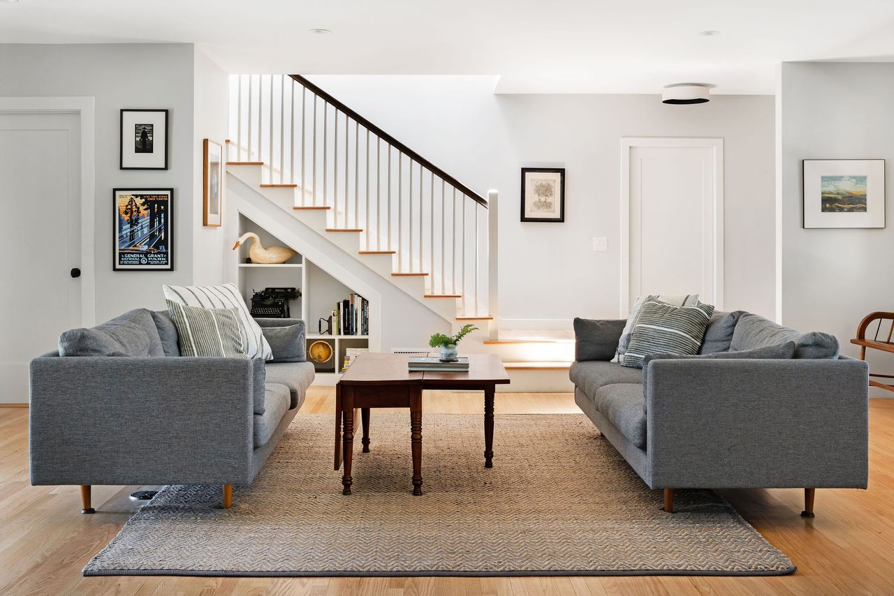 An open plan living area with twin grey couches