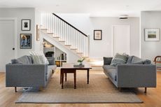An open plan living area with twin grey couches