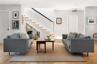 An open plan living area with twin grey couches