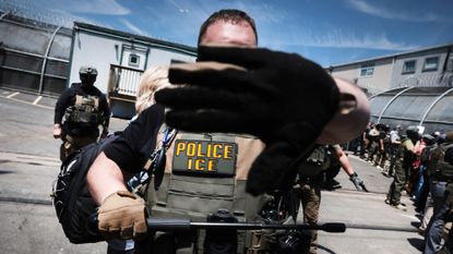 ICE agents stand guard in front of protesters outside Delaney Hall migrant detention center in New Jersey