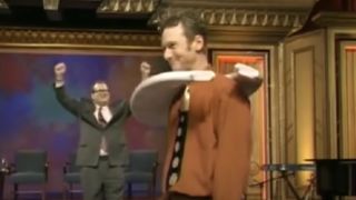 Drew celebrates his horseshoe score around Ryan on Whose Line Is It Anyway?