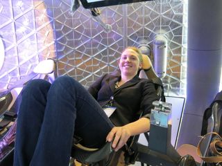 Staff writer Tanya Lewis sits inside the manned Dragon capsule on June 10, 2014.