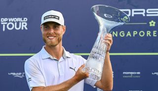 Jesper Svennson holds the Porsche Singapore Classic trophy aloft