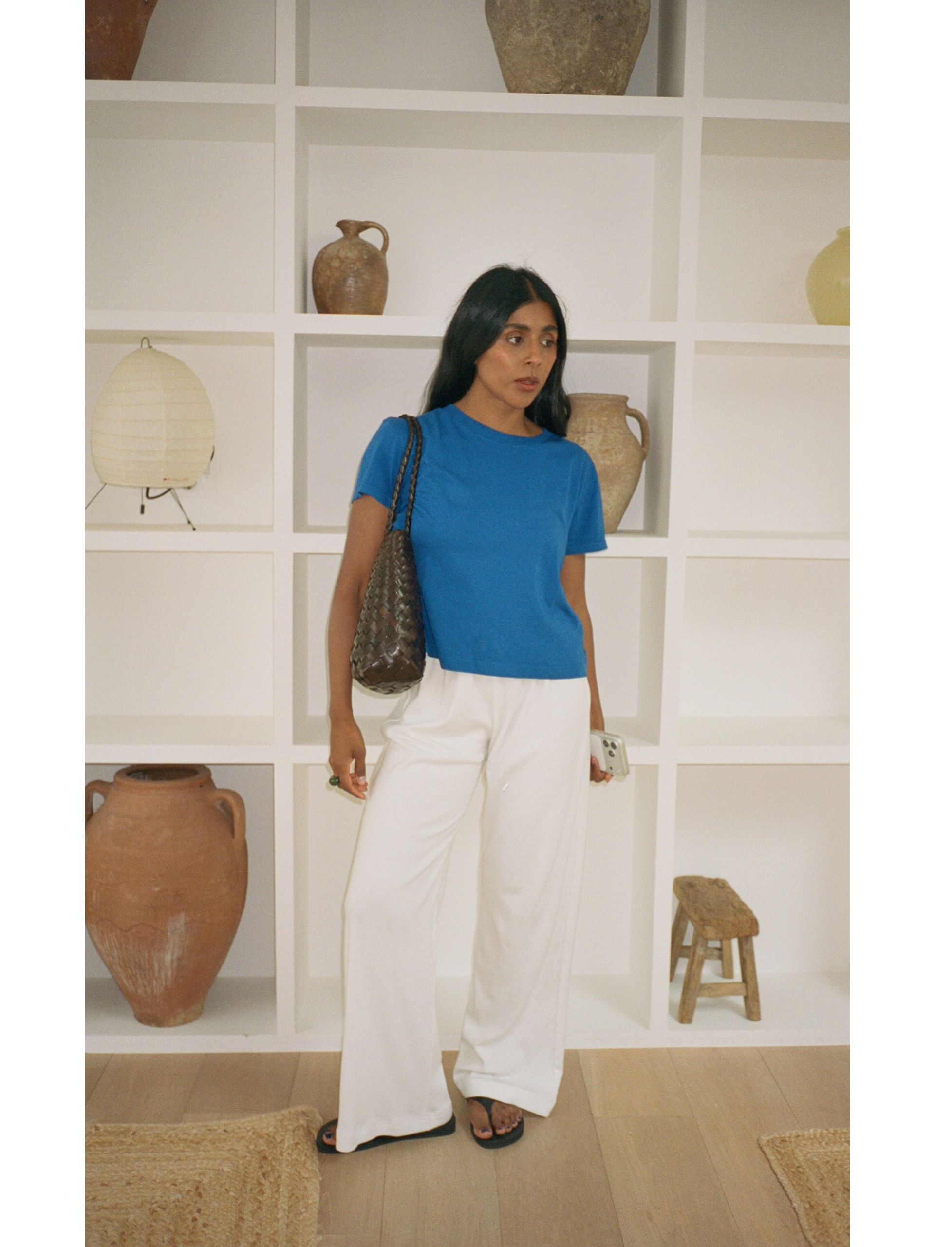 Woman wearing summer 2026 outfit featuring the colorful t-shirt trend.