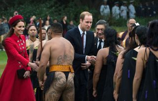 Britain's Prince William (C) and his wife Catherine (L) meet a Maori performance group during a welcoming ceremony at Government House in Wellington on April 7, 2014.Britain's Prince William,