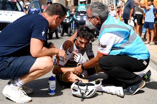 Alaphilippe clutching his collar bone after his crash at the Vuelta 2022