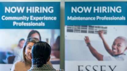 A woman talks to a recruiter at a Seattle job fair